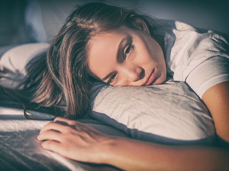 woman in bed in pain